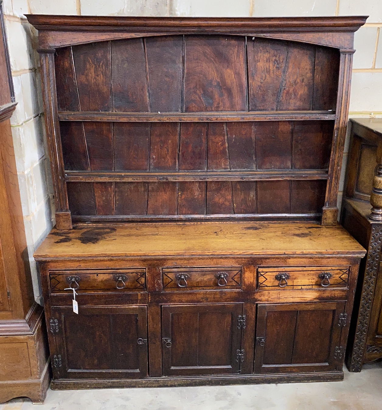 An 18th century provincial oak and elm dresser with associated boarded rack, length 163cm, depth 49cm, height 190cm